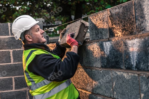 Preview: Workers laying bricks on construction site