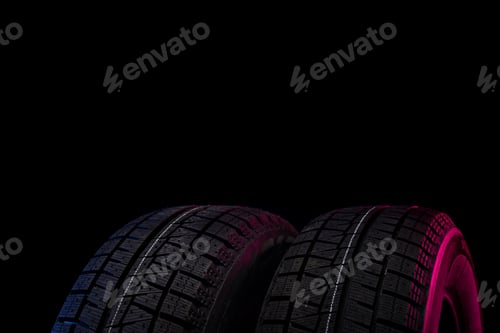 Preview: two black tires with winter tread on a black background