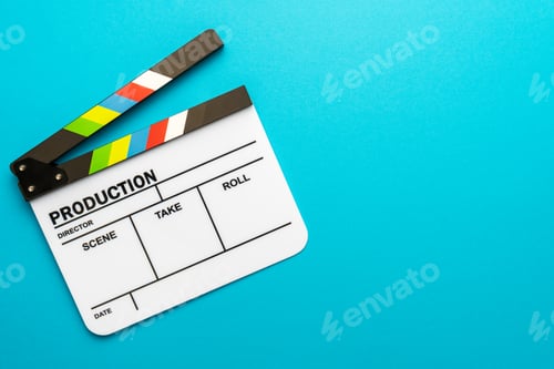 Preview: Top View Of Open White Clapperboard On Turquoise Blue Background And Copy Space
