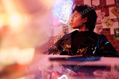 Preview: Young serious African American woman in glamorous jacket looking aside