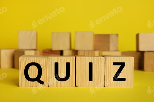 Preview: Wooden cubes with word Quiz on yellow background. Space for text