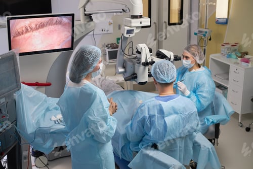 Preview: Group of Surgeons Performing Eye Surgery in Modern Operating Room