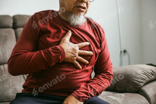Preview: Senior Man Holding His Chest And Feeling Pain Suffering From Heart Attack At The Living Room
