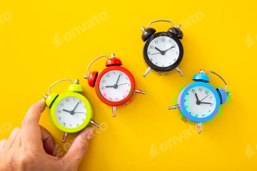 Preview: Hand choosing a green alarm clock
