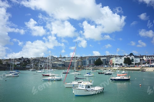 Preview: Beautiful shot of boats and buildings in the seaport with a cloudy blue sky in the background
