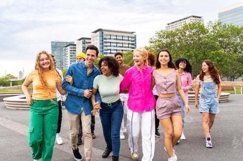 Preview: Group of friends walking together in urban park