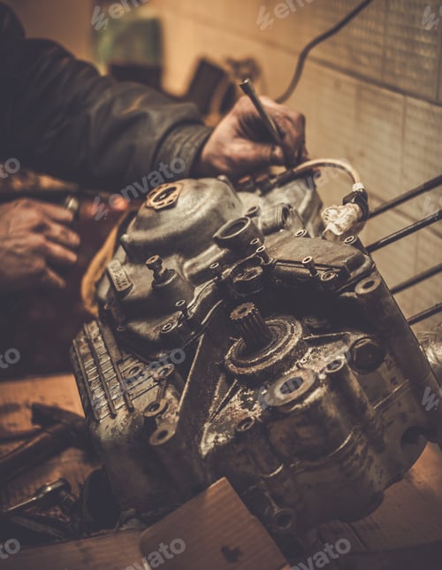 Preview: Mechanic working with with motorcycle engine in a workshop