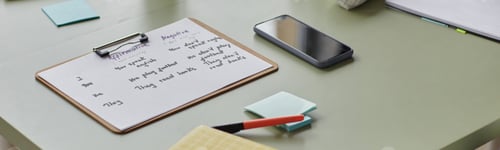 Preview: Header Image of Clipboard with English Grammar Exercises on Desk