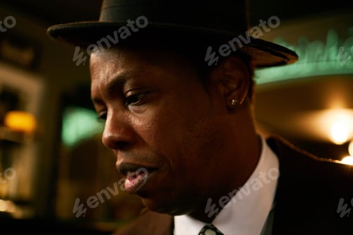 Preview: Black Male Singer in Hat Focused on Music Performance in Jazz Club