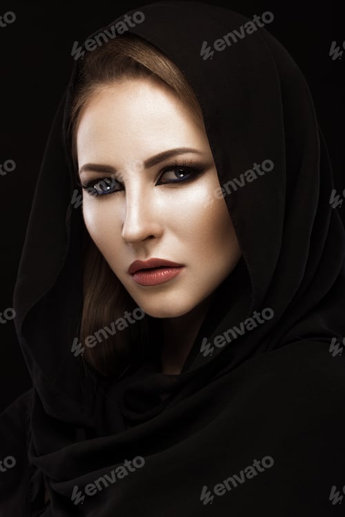 Preview: Beautiful girl in the Arab scarf with oriental make-up. Beauty face.