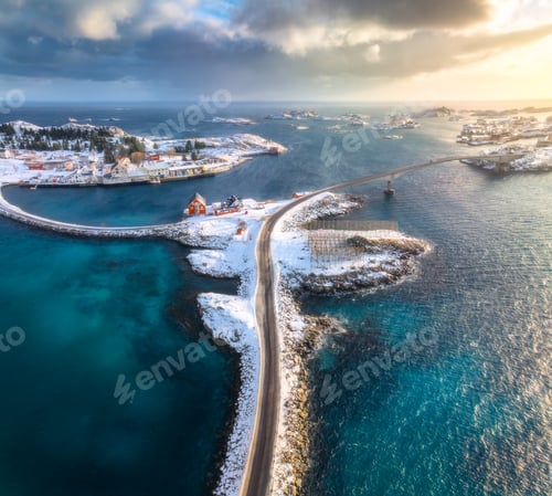 Preview: Aerial view of road, bridges, snowy islands, rorbu, sea at sunset