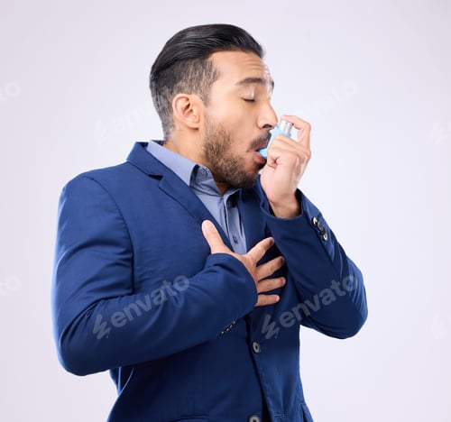 Preview: Business man breathe asthma pump in studio, medical health risk and cough treatment for chest pain.
