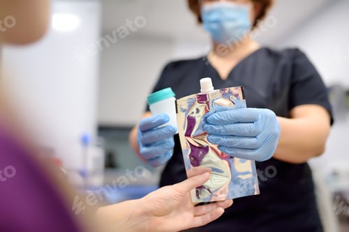 Preview: A nurse offers the patient a medical balloon for blowing to perform a test for Helicobacter