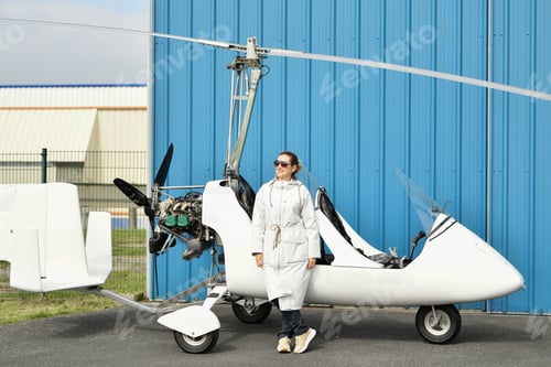 Preview: A woman near two-seater white gyrocopter