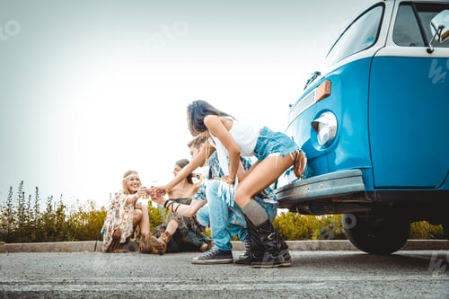 Preview: Happy friends driving a vintage minivan