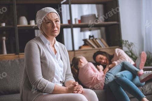 Preview: pensive sick mature woman in kerchief looking away