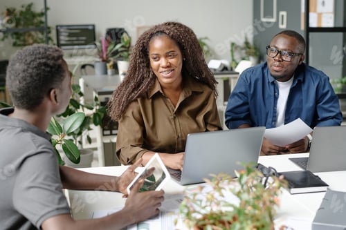 Preview: Woman Smiling while Looking at Colleague