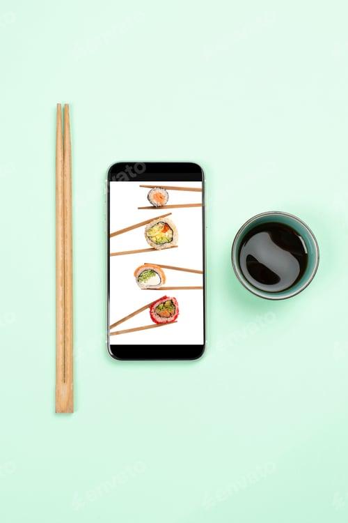 Preview: Online Food Delivery Concept, Sushi On Phone'S Screen And Soy Sauce And Chopsticks