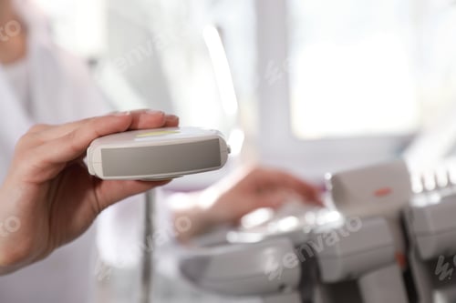 Preview: Sonographer holding ultrasound machine probe in clinic, closeup with space for text