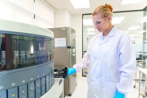 Preview: Laboratory technician operates centrifuge in a research facility during daytime work hours