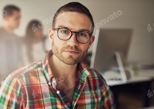 Preview: Handsome bearded worker in small office
