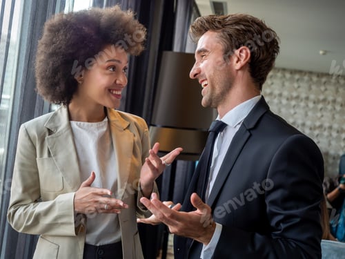 Preview: Happy business colleagues talking in modern office