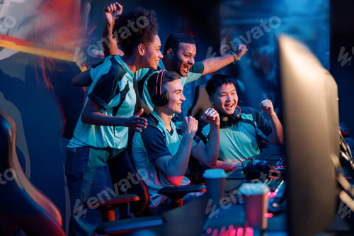 Preview: Team of professional cybersport gamers celebrating success in gaming club