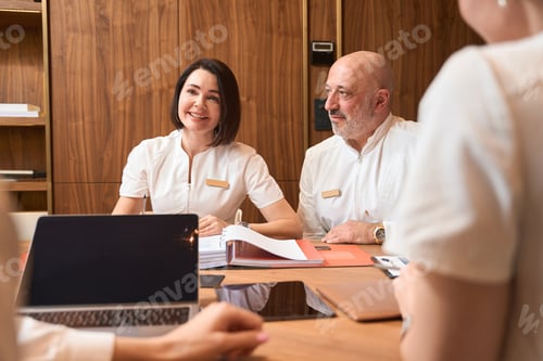 Preview: Doctors sit at a table with laptops and documents