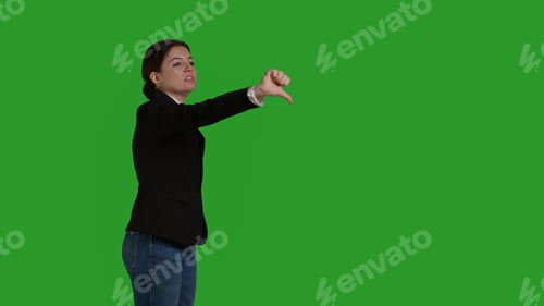 Preview: Side view of corporate employee giving thumbs down symbol in studio