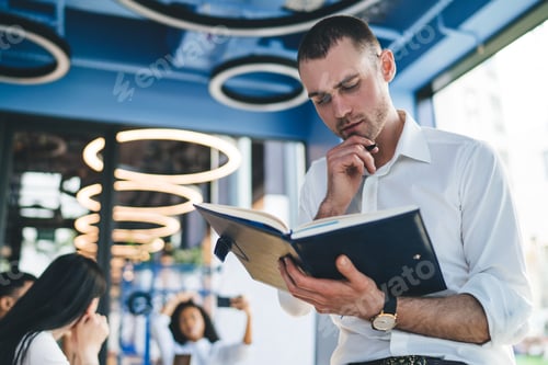 Preview: Thoughtful guy preparing report at workplace
