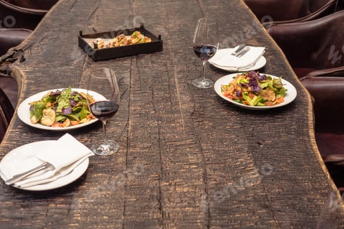 Preview: delicious salad with wine on rustic wooden table for romantic dinner