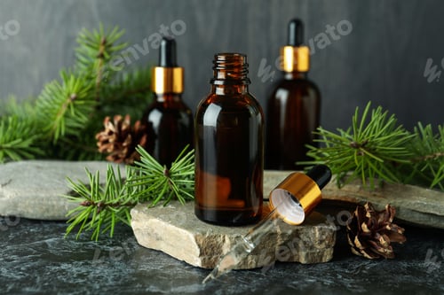 Preview: Aromatherapy concept with pine oil on black smoky table