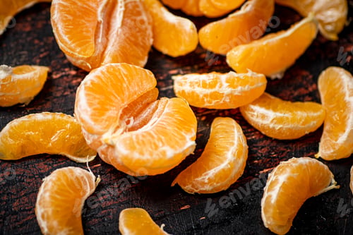 Preview: Peeled tangerines. Against a dark background.
