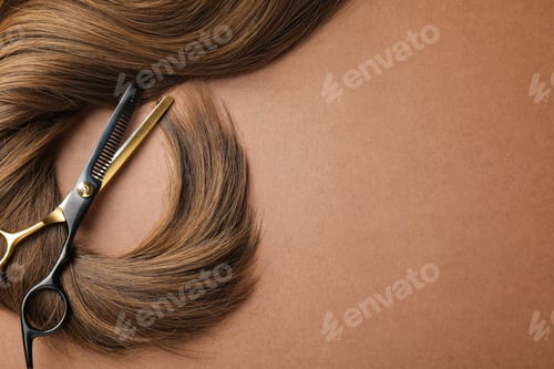 Preview: Lock of beautiful hair and scissors on light brown background, top view. Space for text