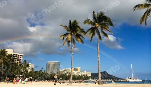 Preview: Tourists enjoying a beautiful Hawaiian beach day a rainbow, palm trees & Diamond Head in the back