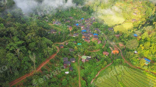 Preview: Aerial view from drone of the rural village in the mountains on foggy day