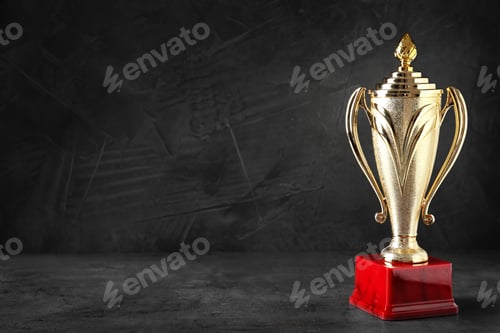 Preview: Golden trophy cup on black background. Space for text