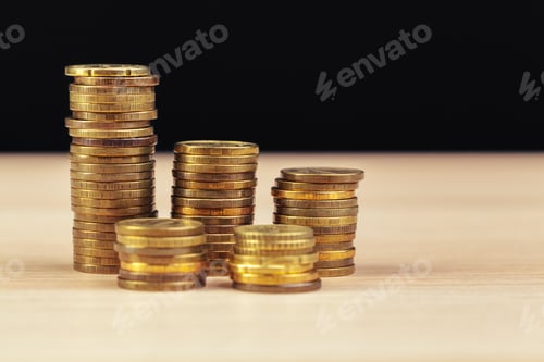Preview: piles of coins on working table. creative photo