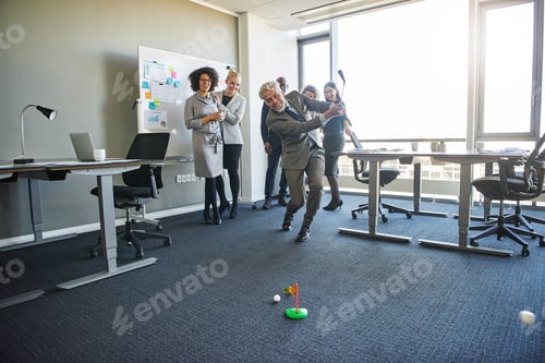 Preview: Office colleagues enjoying a light hearted game of mini golf
