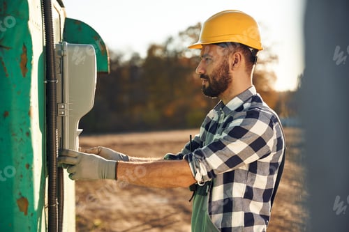 Preview: Adult Wearing Hard Hat and Flannel Outdoors