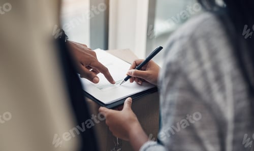 Preview: Cropped shot of a woman signing for a delivery received at home