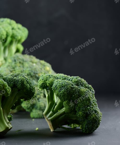 Preview: Fresh green head of broccoli on black background