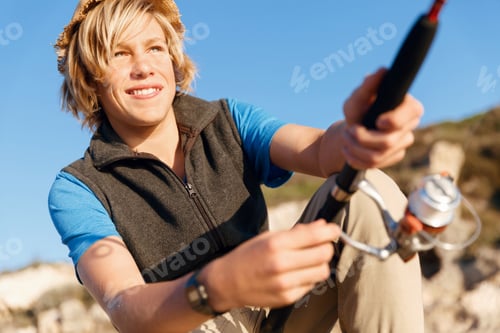Preview: Teenage boy fishing at sea
