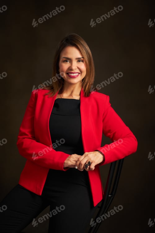 Preview: Professional Woman in Red Jacket Posing in Studio