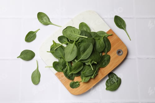 Preview: Fresh spinach leaves on white tiled table, flat lay