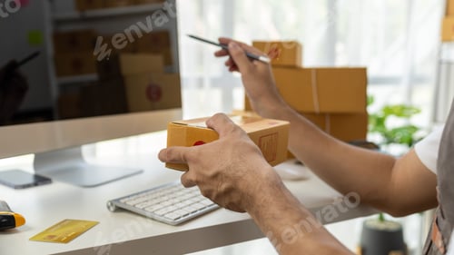 Preview: Male online shop owner, he checks orders on computer, online shop owner distributes products on webs