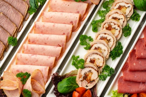 Preview: Platter of fresh meat cold cuts with vegetables.