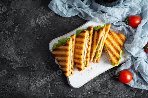 Preview: Club sandwich with ham, tomato, green and cheese. Grilled panini. Top view