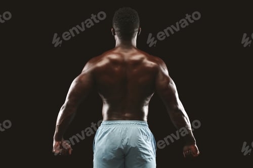 Preview: Unrecognizable black sportsman showing strong back muscles