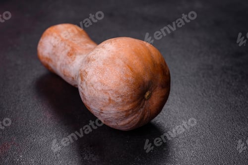 Preview: A beautiful fresh orange pumpkin against a dark concrete background
